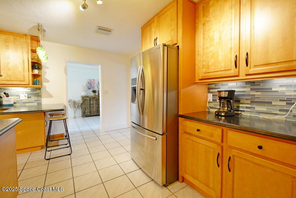 15 Hardee Circle South Rockledge, FL 32955 - Photo 12 of 44 a kitchen with stainless steel appliances granite countertop a refrigerator and a sink