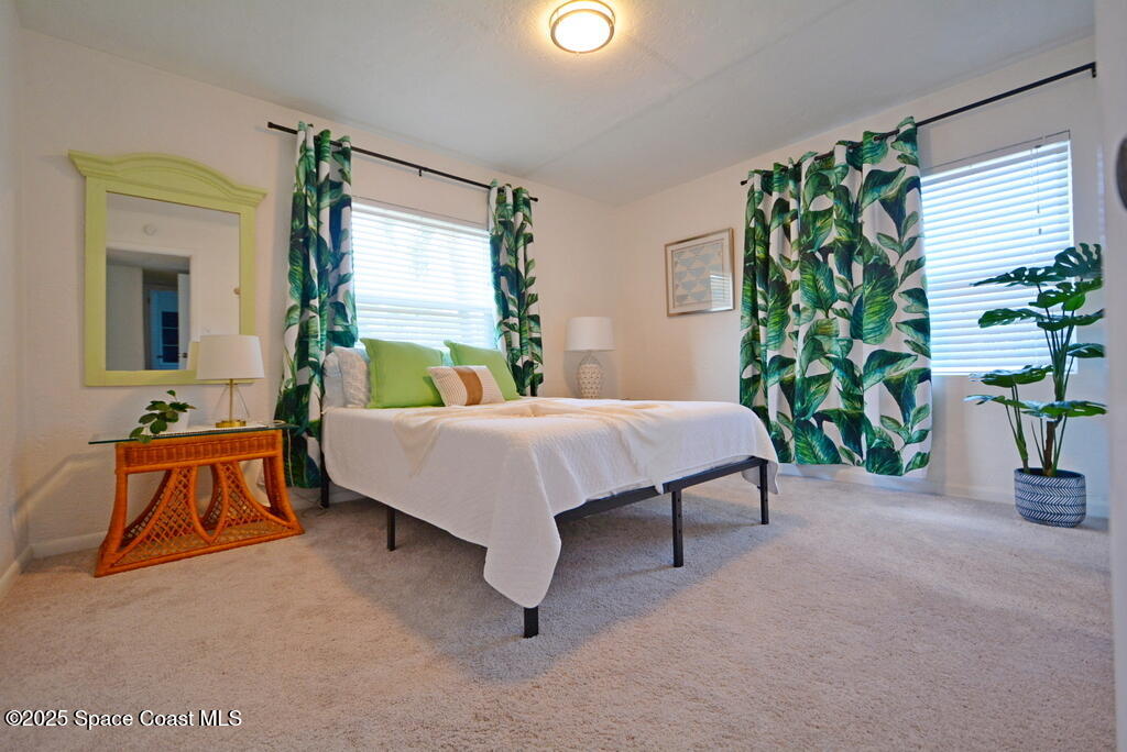 15 Hardee Circle South Rockledge, FL 32955 - Photo 16 of 44 a bedroom with a bed and a potted plant