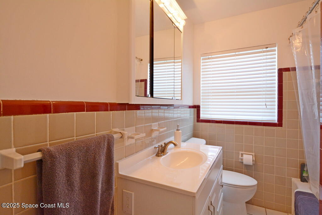 15 Hardee Circle South Rockledge, FL 32955 - Photo 18 of 44 a bathroom with a sink a toilet and a mirror