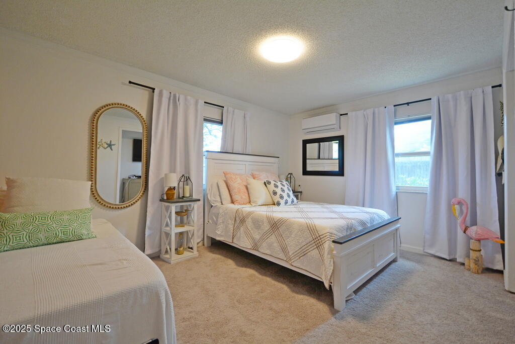 15 Hardee Circle South Rockledge, FL 32955 - Photo 21 of 44 a spacious bedroom with a bed and large windows