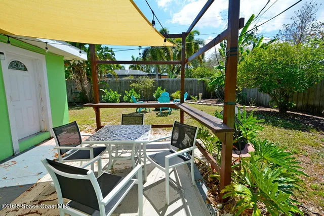 a view of an outdoor sitting area with furniture and wooden floor
