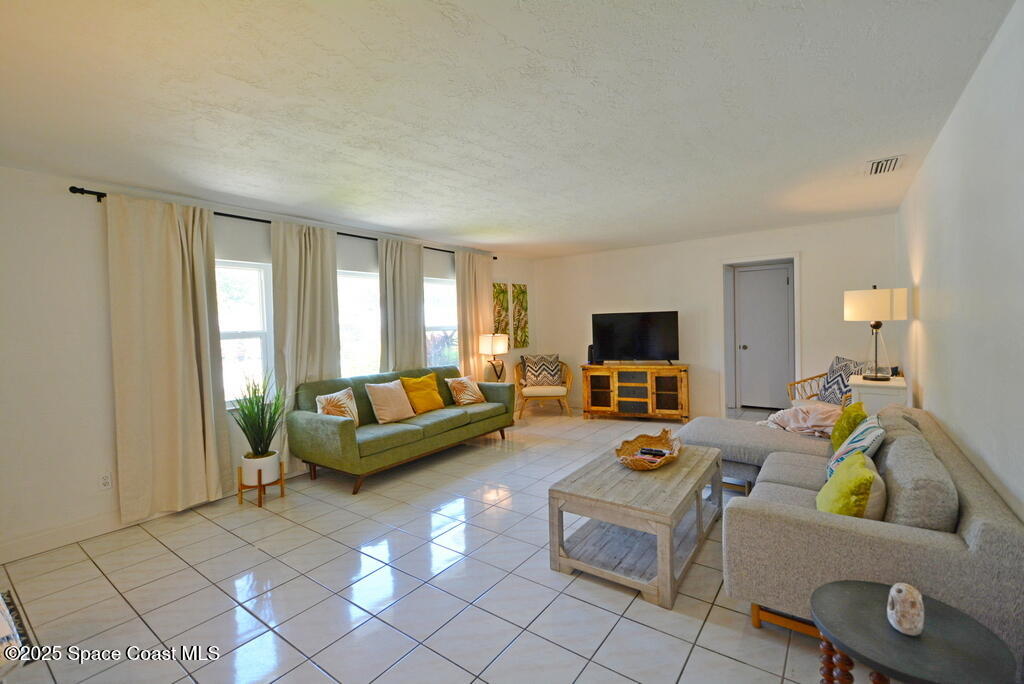 15 Hardee Circle South Rockledge, FL 32955 - Photo 3 of 44 a living room with furniture and a flat screen tv