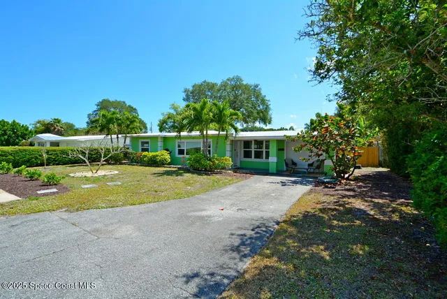 a view of backyard with outdoor seating and green space