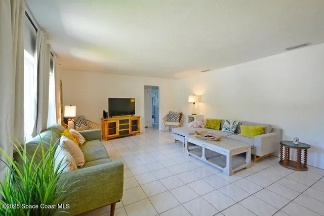 a bedroom with furniture and a flat screen tv