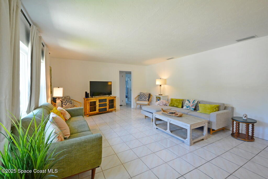 15 Hardee Circle South Rockledge, FL 32955 - Photo 4 of 44 a bedroom with furniture and a flat screen tv