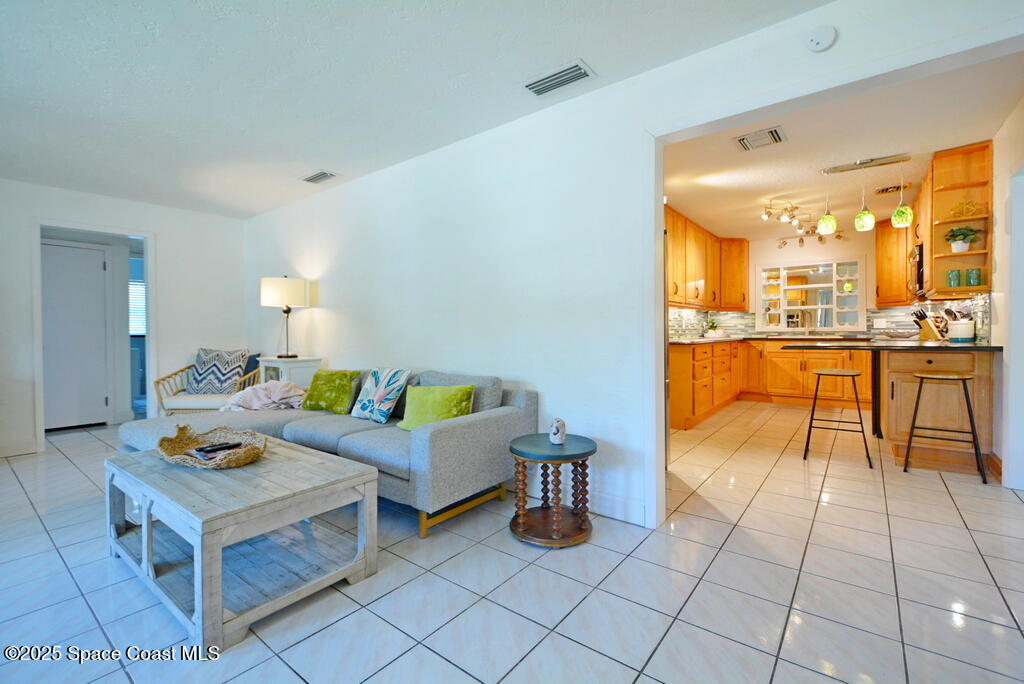 15 Hardee Circle South Rockledge, FL 32955 - Photo 5 of 44 a living room with furniture and a dining table with kitchen view