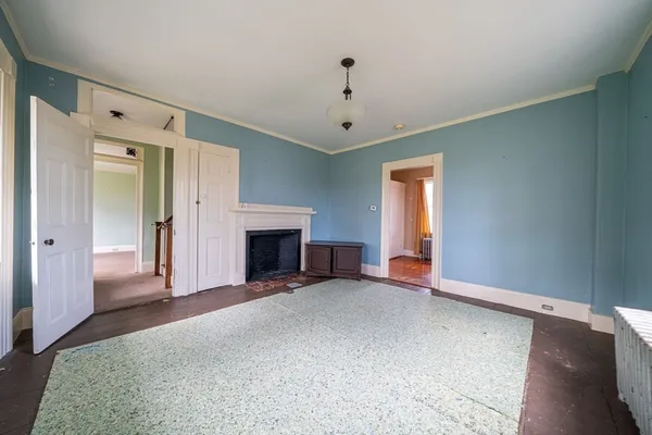 a view of a livingroom with a fireplace and window