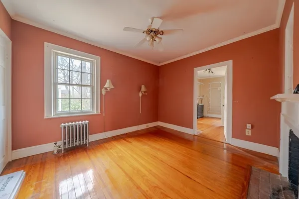 a view of an empty room with a window and a potted plant