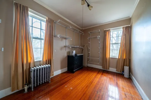 a kitchen with stainless steel appliances granite countertop a refrigerator a sink and wooden floor