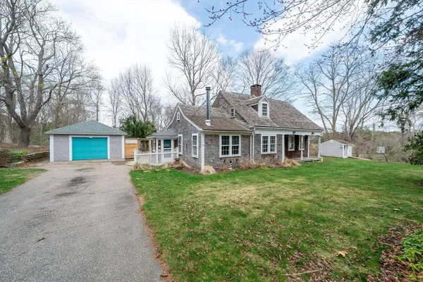 a front view of a house with yard and green space