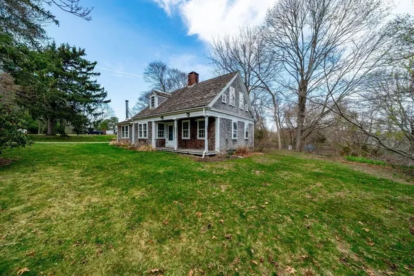 a view of a house with a yard and sitting area