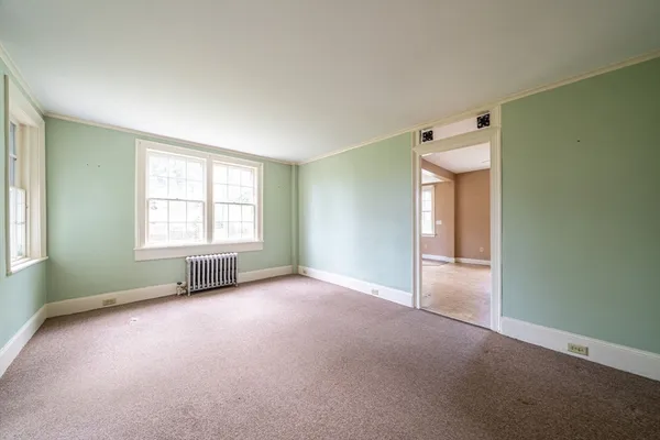 an empty room with windows and closet