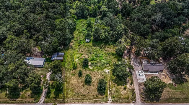 an aerial view of a house with yard and outdoor seating