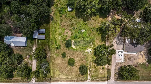 an aerial view of a house with a yard