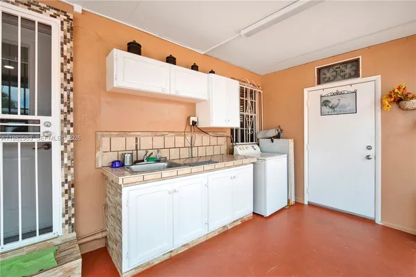 a kitchen with a sink stove and cabinets