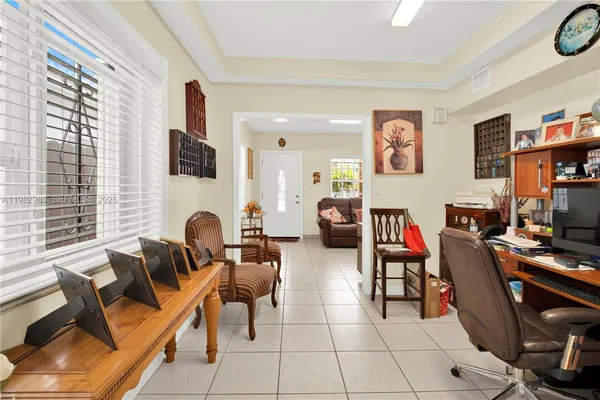 a living room with furniture a flat screen tv and a window