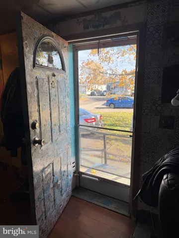 a view of empty room with a fireplace and windows