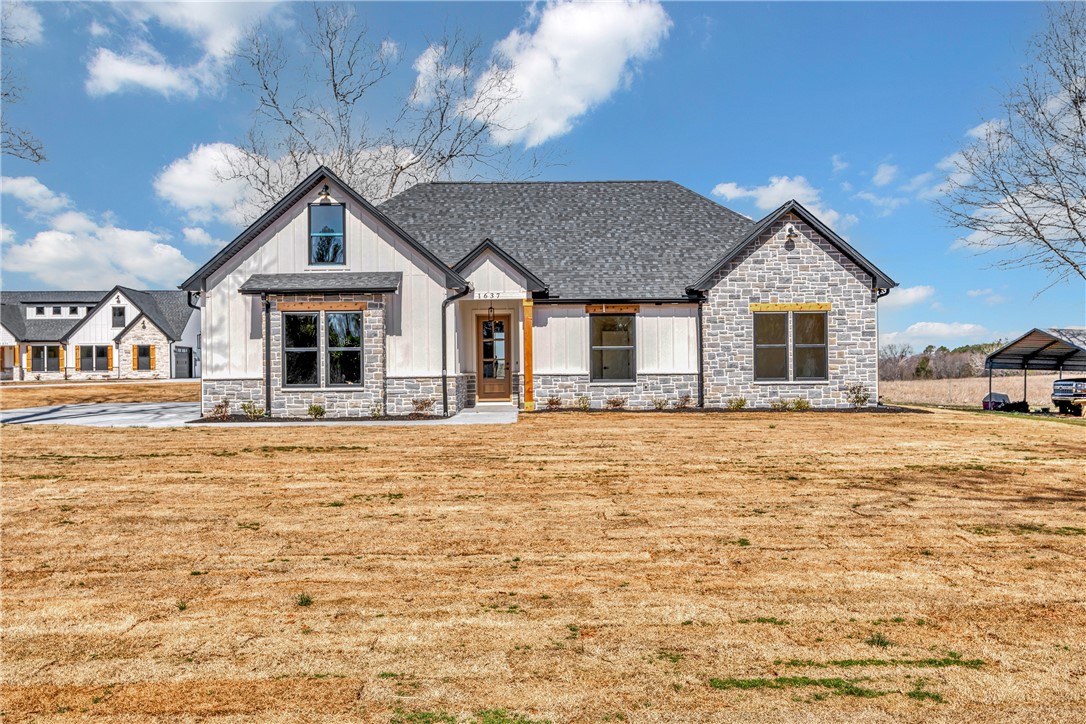 2816 Smith McGee Road Iva, SC 29655 - Photo 4 of 25 Crafted with board and batten siding and stone accents, this home presents a welcoming facade.