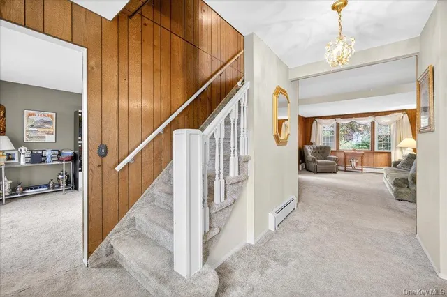 a view of hallway with stairs and furniture