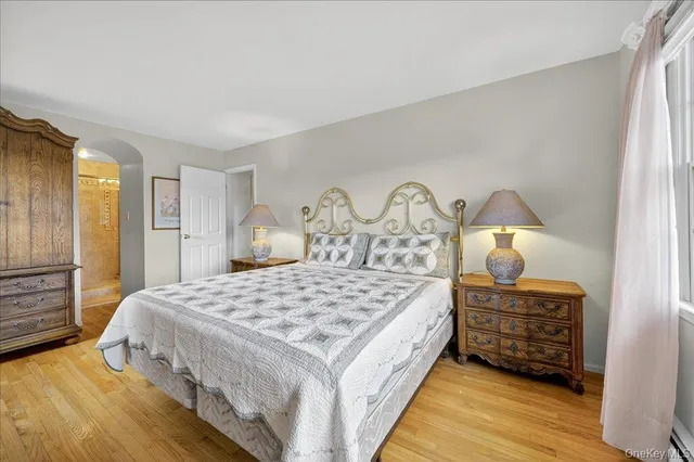 a spacious bathroom with a granite countertop toilet sink and mirror