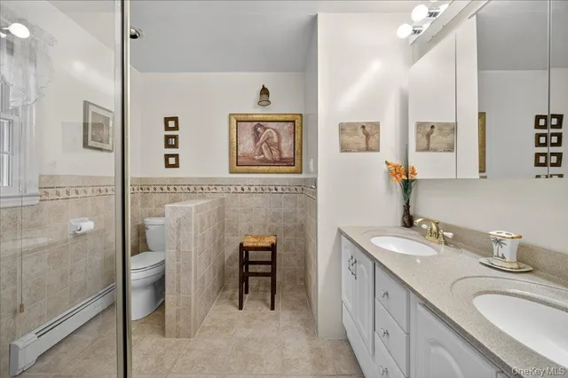 a spacious bathroom with a shower sink and mirror