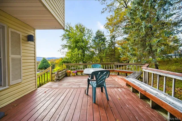 a view of a chairs and table on the deck