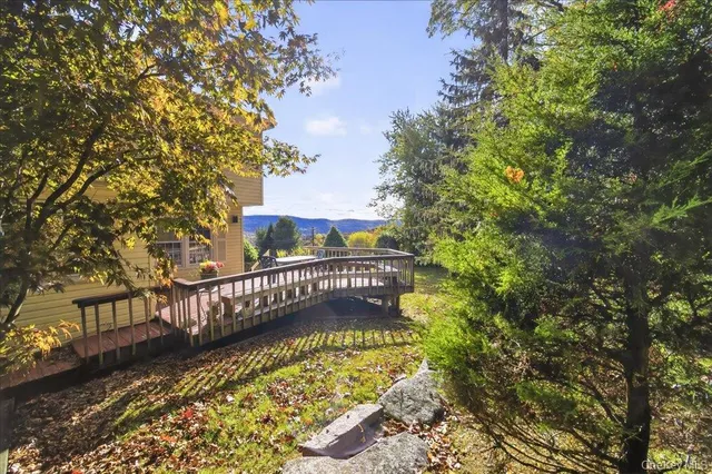 a backyard of a house with table and chairs