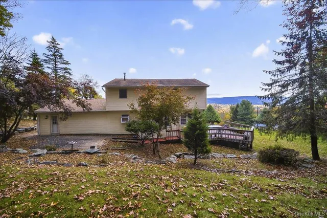 a view of a yard with plants and a tree