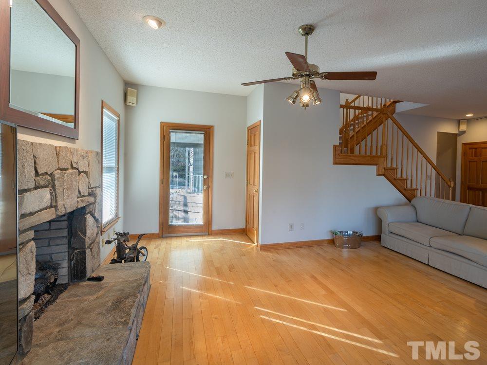 935 Dick Holeman Road Timberlake, NC 27583 - Photo 22 of 30 a view of a livingroom with furniture and a ceiling fan