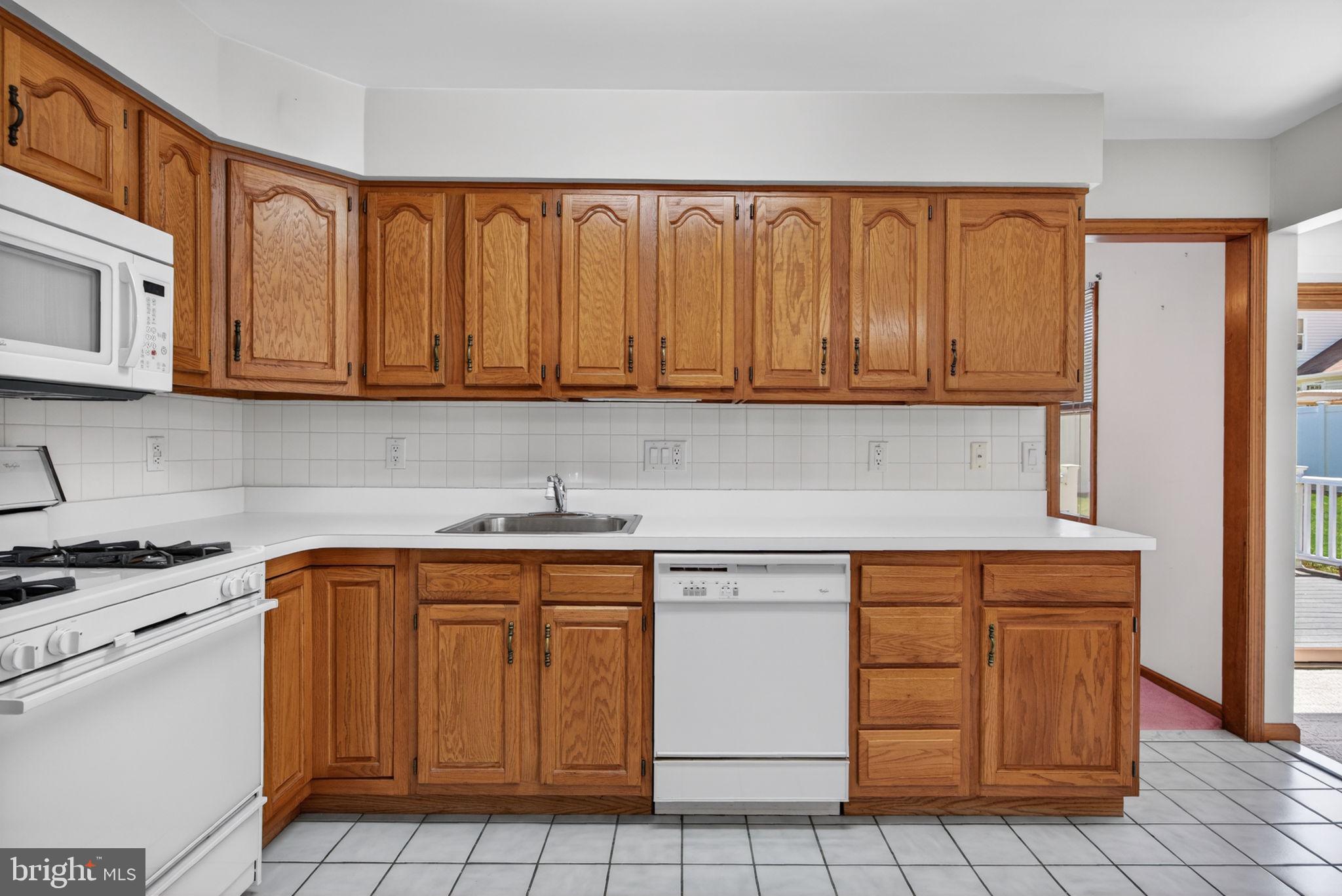 504 Ash Street Glassboro, NJ 08028 - Photo 13 of 42 a kitchen with white cabinets and white appliances