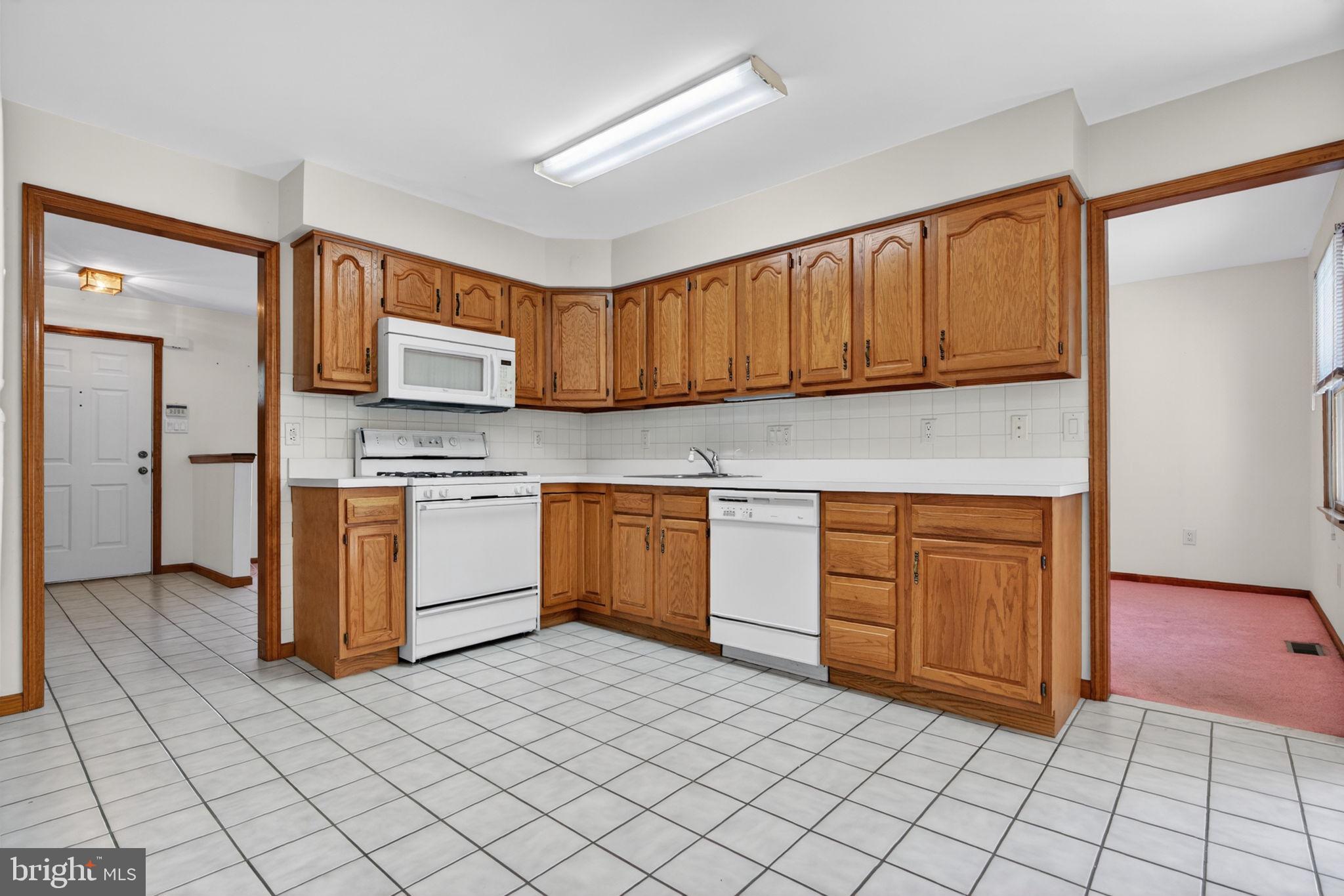 504 Ash Street Glassboro, NJ 08028 - Photo 14 of 42 a kitchen with stainless steel appliances granite countertop a stove a sink and a refrigerator