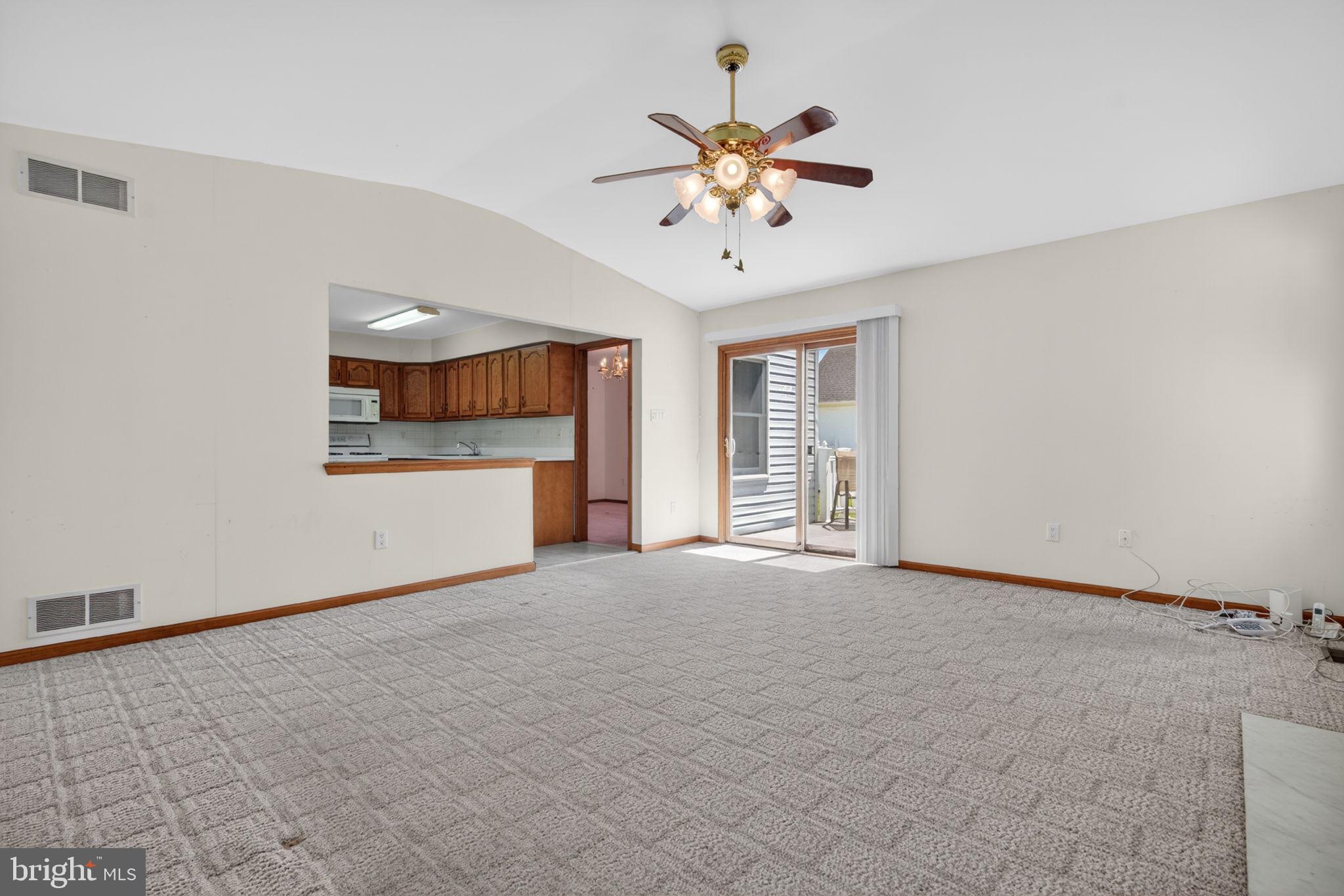 504 Ash Street Glassboro, NJ 08028 - Photo 18 of 42 an empty room with chandelier fan and windows