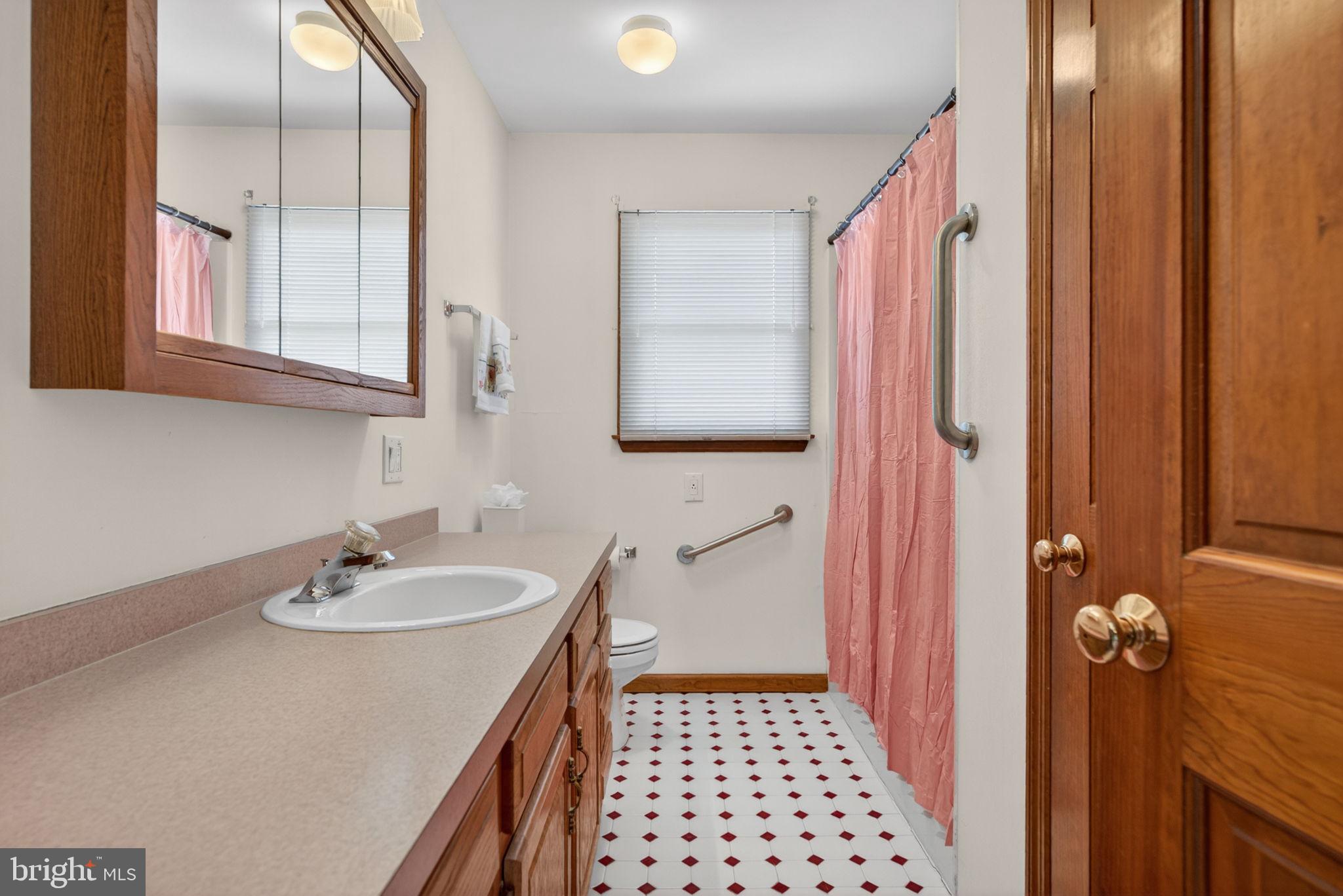 504 Ash Street Glassboro, NJ 08028 - Photo 26 of 42 a bathroom with a sink and a mirror