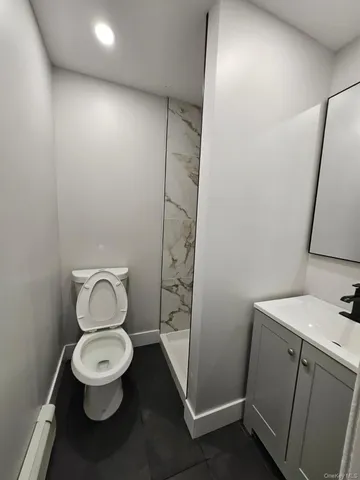 a white toilet sitting next to a bathroom sink