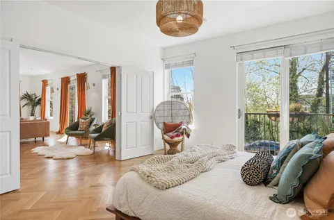 a bedroom with a bed and glass windows