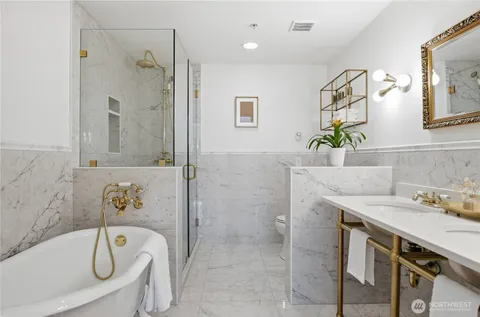 a bathroom with a tub sink and mirror