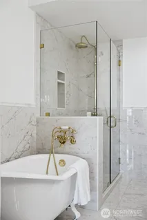 a bathroom with a bathtub and shower