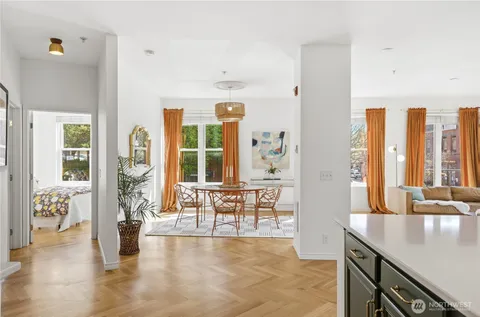 a living room with furniture and large windows