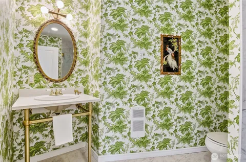 a bathroom with a sink toilet and mirror