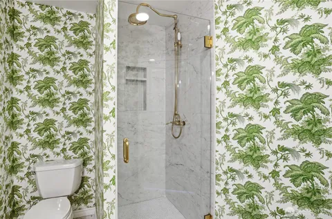 a bathroom with a toilet and shower