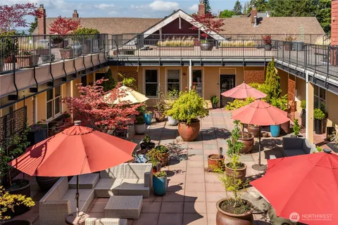 an aerial view of a house with swimming pool and outdoor seating