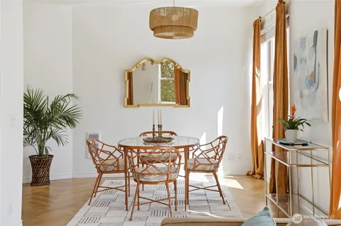 a view of a dining room with furniture and a potted plant