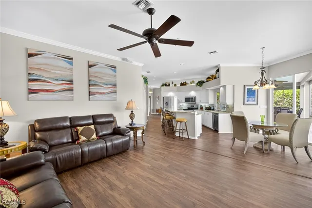 a living room with furniture and kitchen view