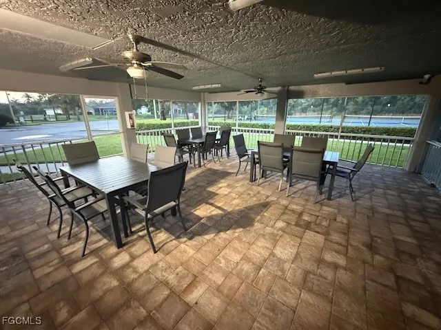 a outdoor space with lots of tables a garden view and chairs
