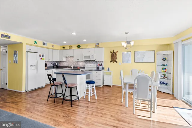 a large kitchen with stainless steel appliances lots of counter space and wooden floor
