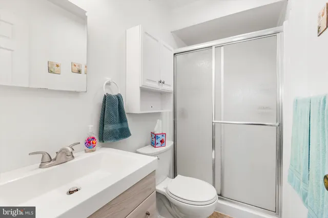 a bathroom with a sink toilet and shower curtain
