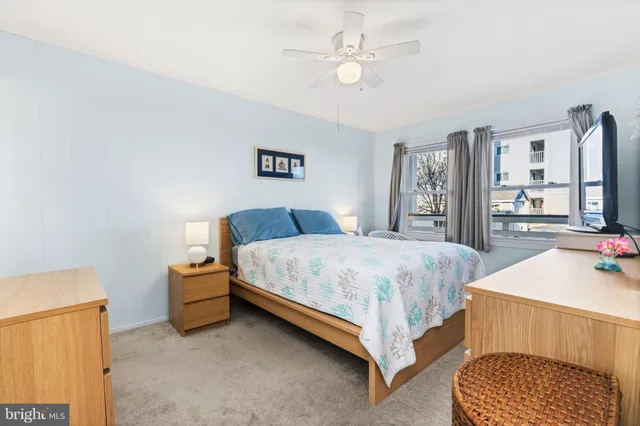 a bedroom with a bed and dresser with mirror