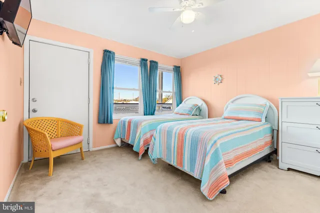 a bedroom with two beds and a chandelier
