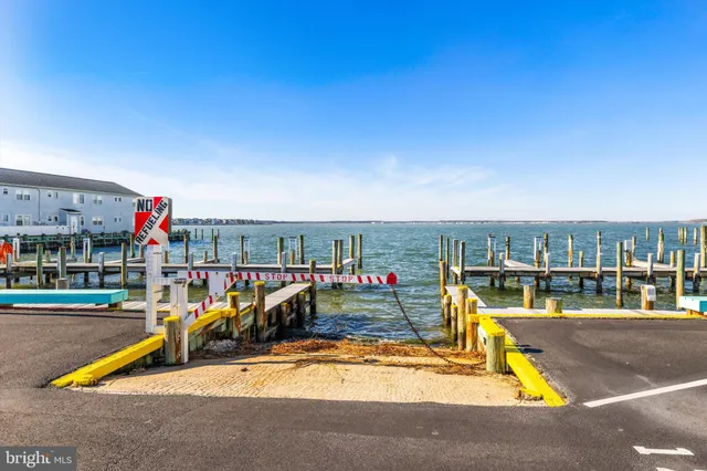 a view of a swimming pool with seating area and potted plants