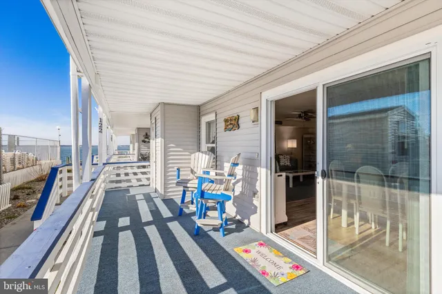 a view of a chairs and table in a balcony